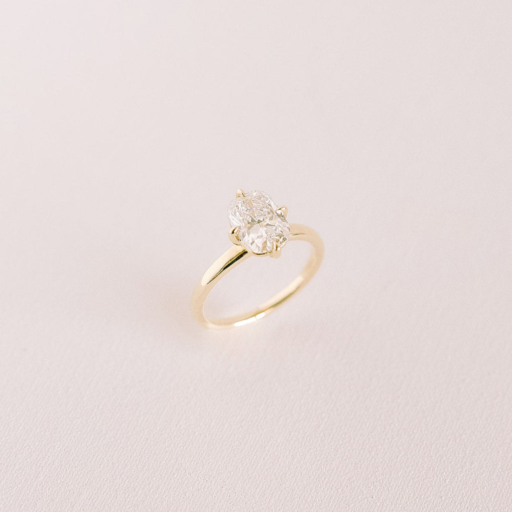 Cushion-cut lab diamond engagement ring in compass prong setting, 14k yellow gold band, Northstar design.