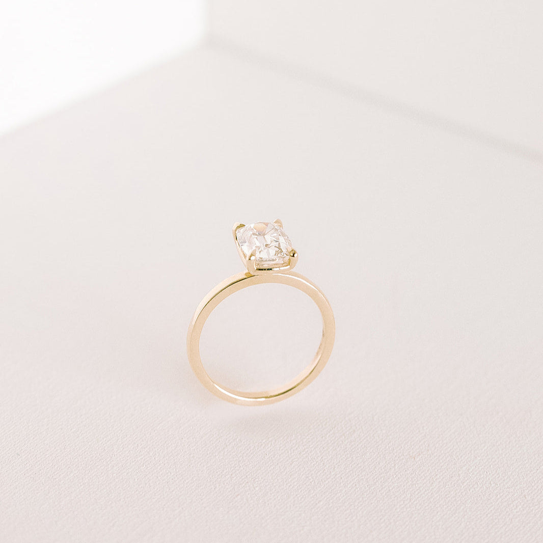 Heirloom engagement ring side angle, old mine cut cushion lab diamond solitaire in yellow gold band.
