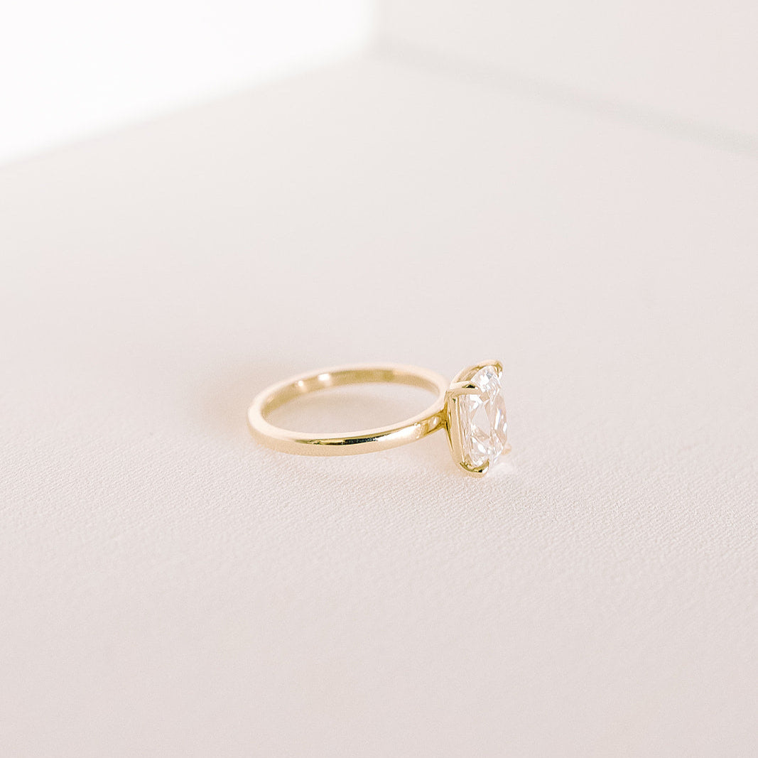 Heirloom engagement ring featuring elongated old mine cut lab diamond in 14k yellow gold, side profile.”