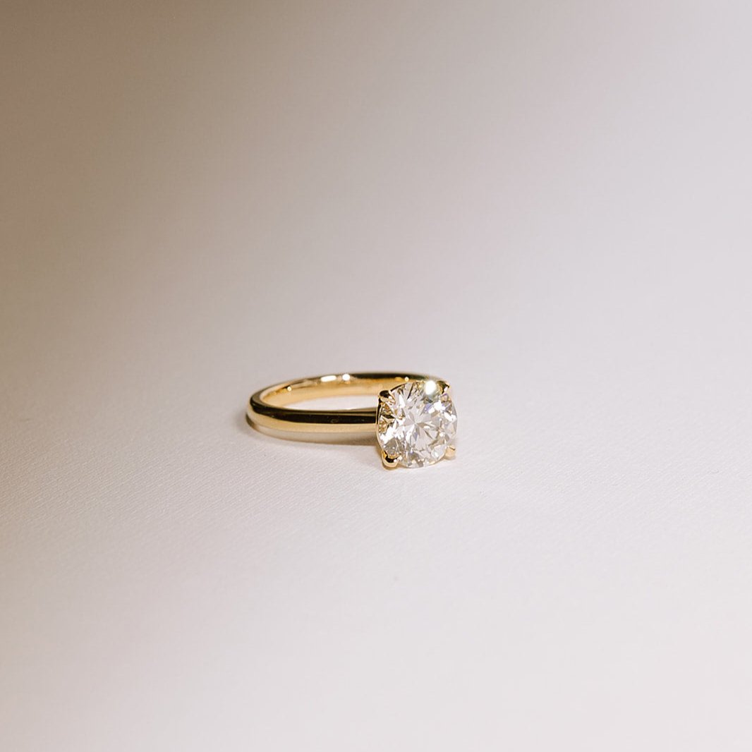 2.01 carat round lab diamond engagement ring in 14k yellow gold, angled view showing brilliance and sparkle.