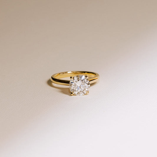 Close-up of round solitaire lab diamond ring in 14k yellow gold, highlighting the 2.01 carat diamond’s fire and clarity.
