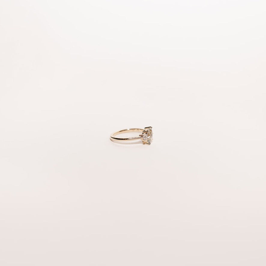 Moonlit Tide toi et moi ring featuring a light green marquise sapphire and round diamond set in 14k yellow gold, side view.