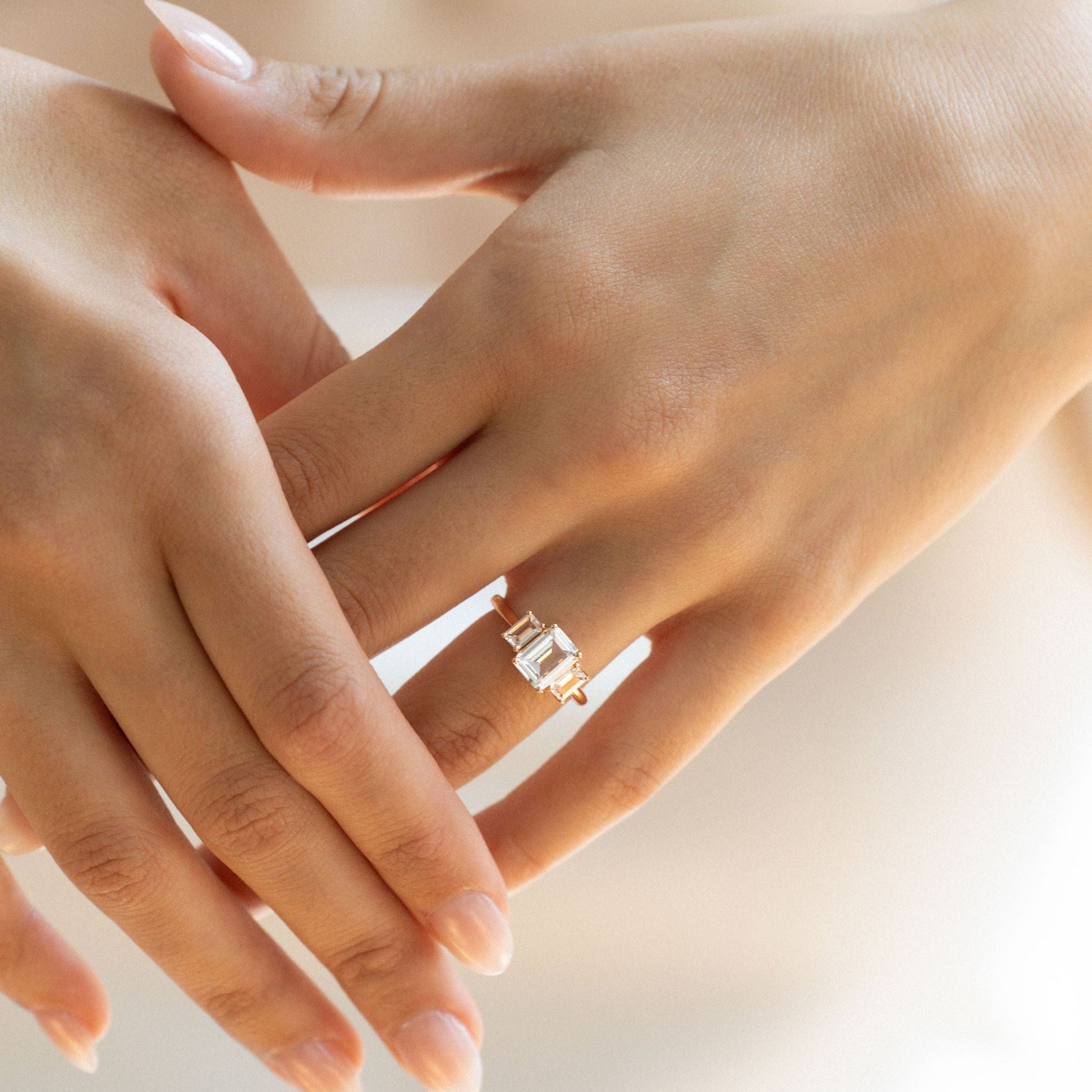 Emerald cut sapphire engagement ring with side diamond baguettes in yellow gold