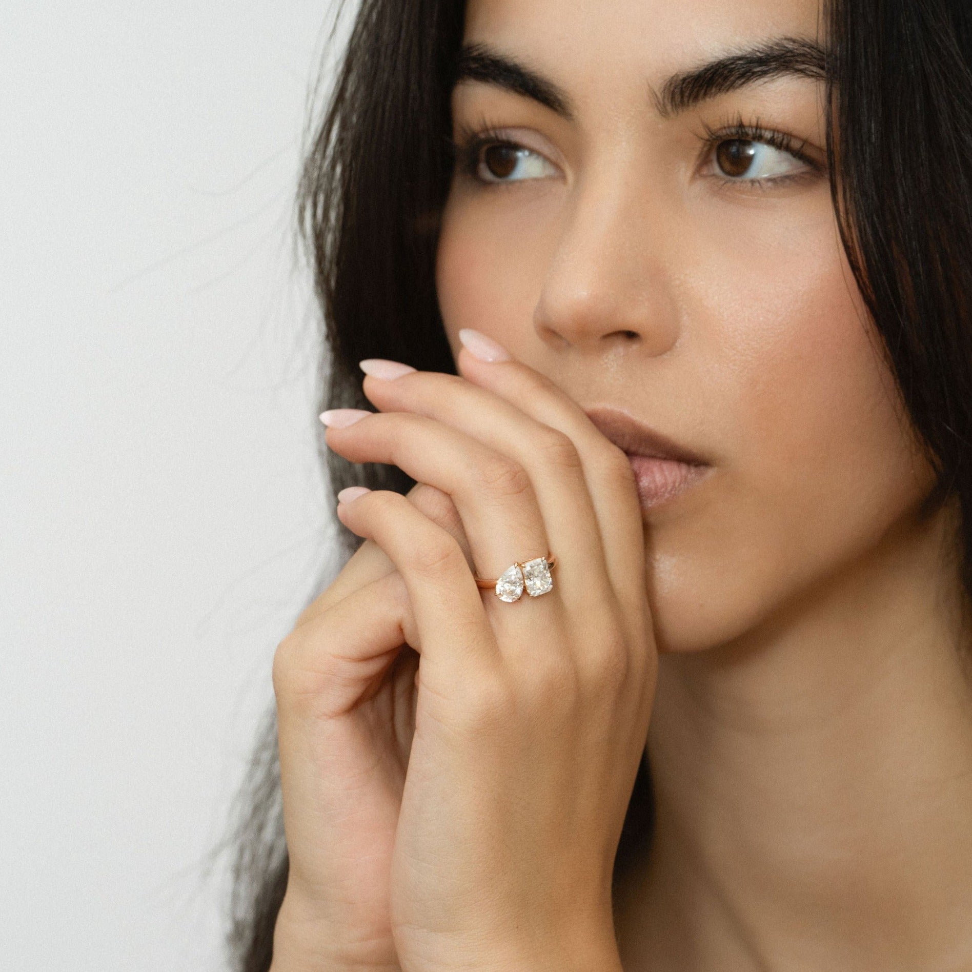 Blissed Out toi et moi engagement ring with pear-shaped and radiant-cut lab diamonds, worn on hand.