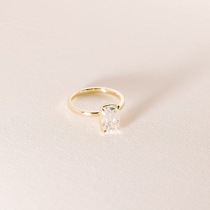 Old mine cut lab diamond solitaire ring in 14k yellow gold with 2.08 carat elongated centre stone on soft neutral background