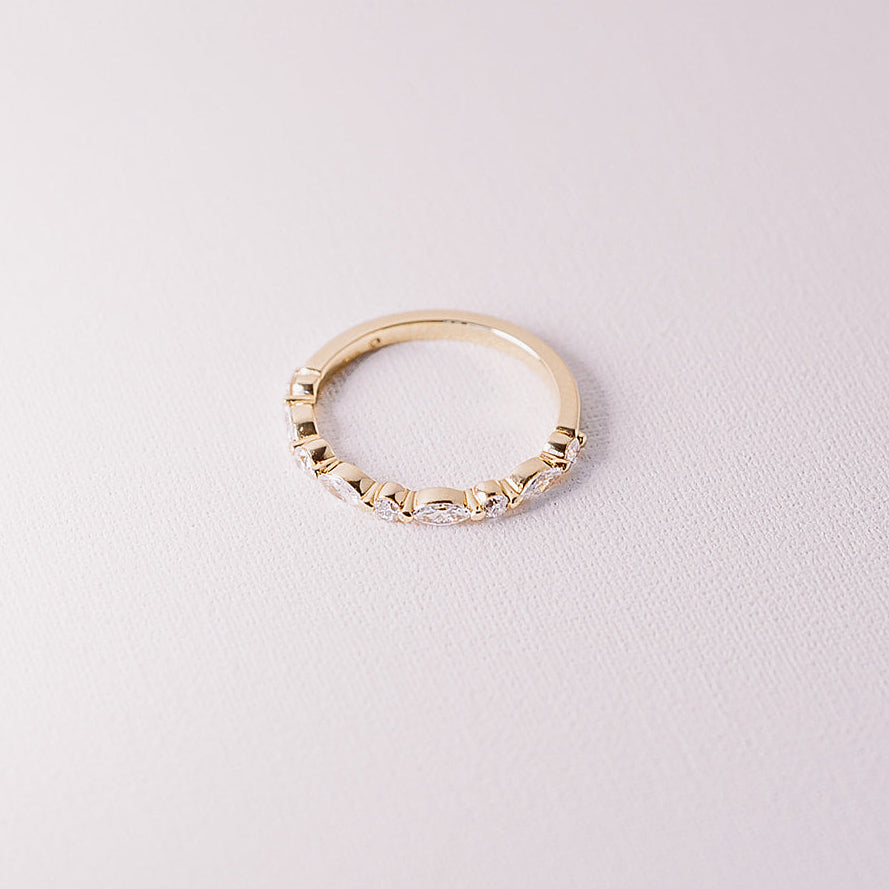 Ever After marquise and round lab diamond half eternity band in 14k yellow gold angled detail view on neutral background