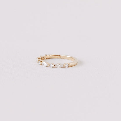 Marquise and round lab diamond half eternity wedding band in 14k yellow gold angled side view on white background