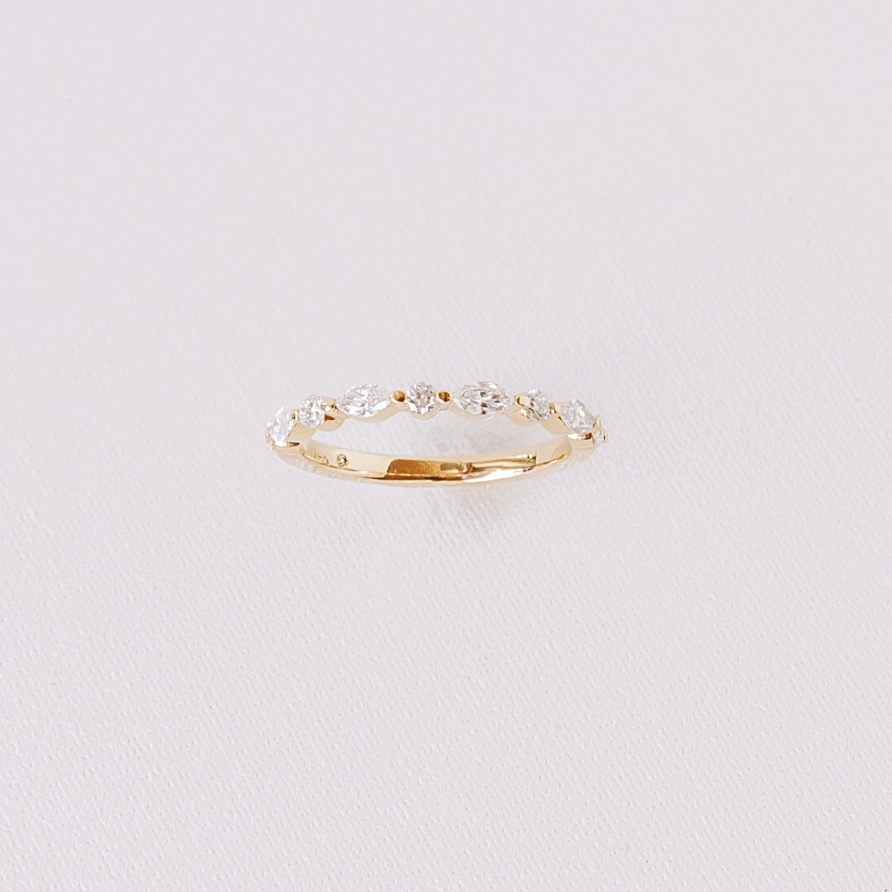 Marquise and round lab diamond half eternity wedding band in 14k yellow gold front view on white background