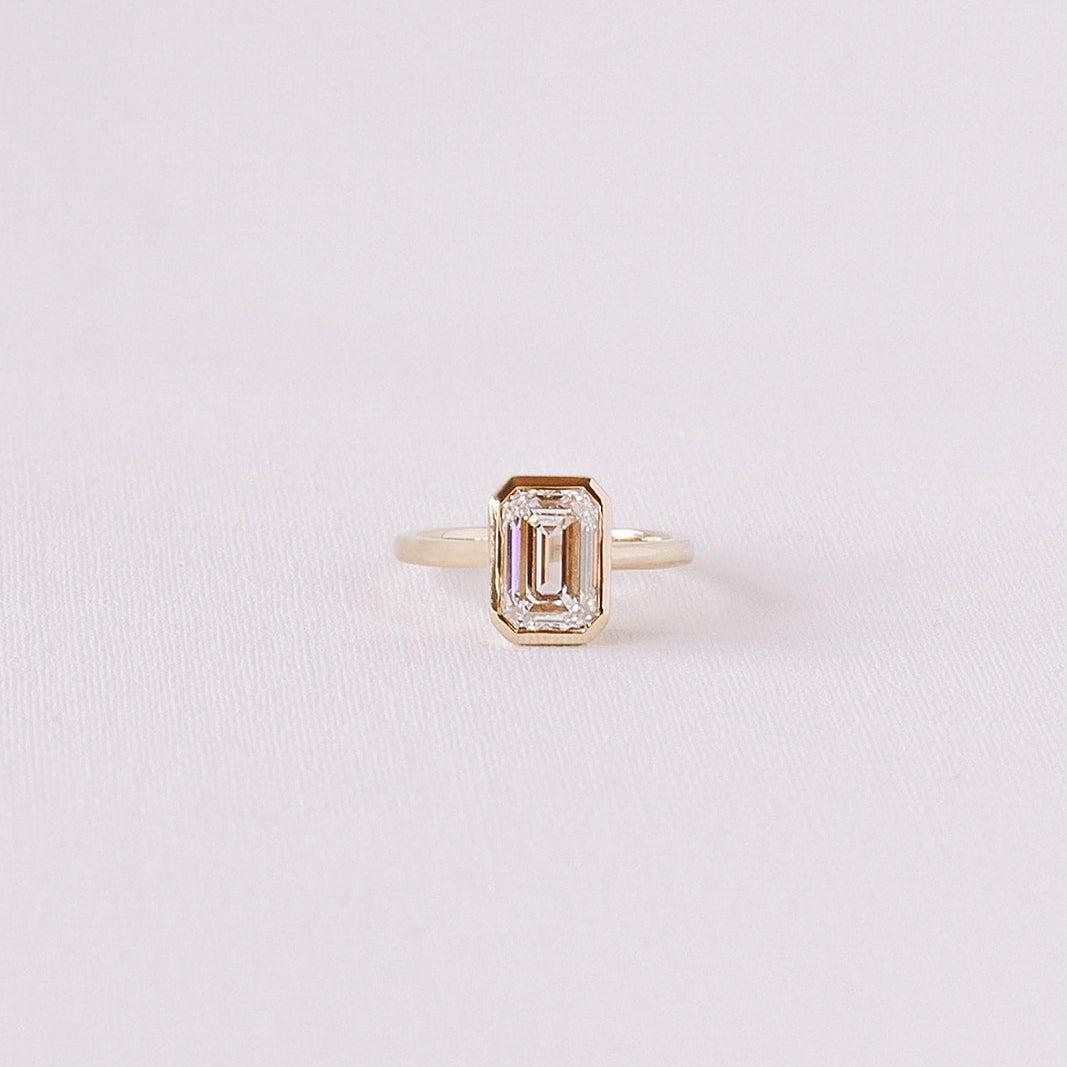 Ma Folie emerald-cut bezel lab diamond engagement ring in 14k yellow gold featuring a 2.53 carat D VVS2 diamond in a clean bezel setting