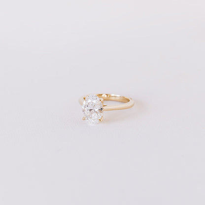 Oval lab-grown diamond solitaire ring with petal cathedral setting in 14k yellow gold, angled view highlighting centre stone and profile