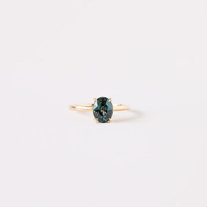 Teal green sapphire oval ring with yellow gold