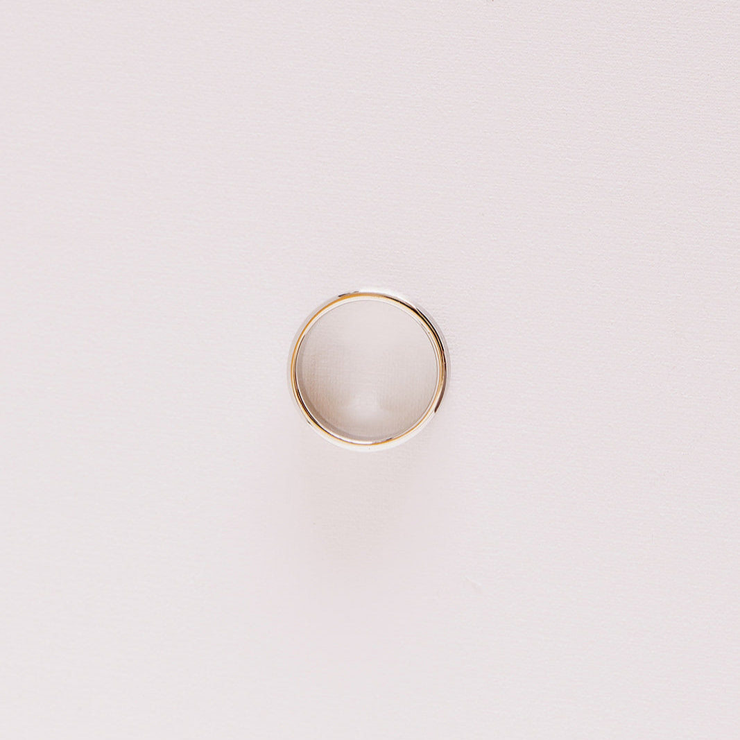 Top-down view of the Vow (Brushed) men’s wedding band lying on its side, showing the circular profile and soft brushed texture in white gold.