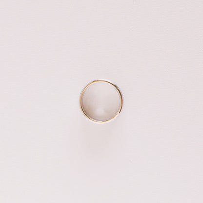 Top-down view of the Vow (Brushed) men’s wedding band lying on its side, showing the circular profile and soft brushed texture in white gold.