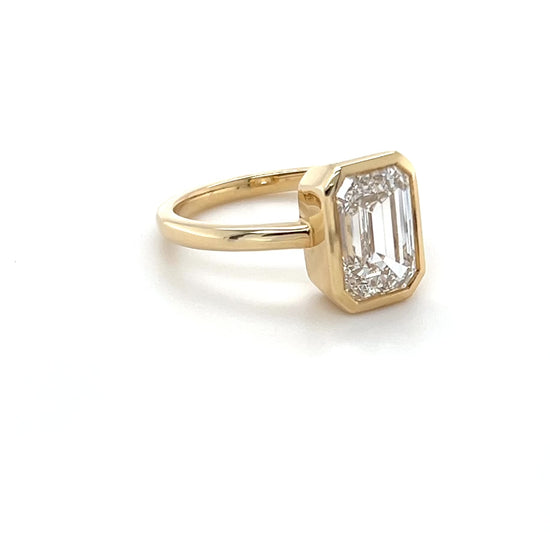 Ma Folie emerald-cut bezel lab diamond engagement ring in 14k yellow gold shown at all angles highlighting the depth of the bezel setting and diamond sparkle
