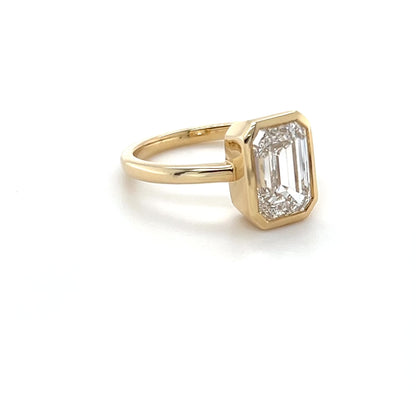 Ma Folie emerald-cut bezel lab diamond engagement ring in 14k yellow gold shown at all angles highlighting the depth of the bezel setting and diamond sparkle