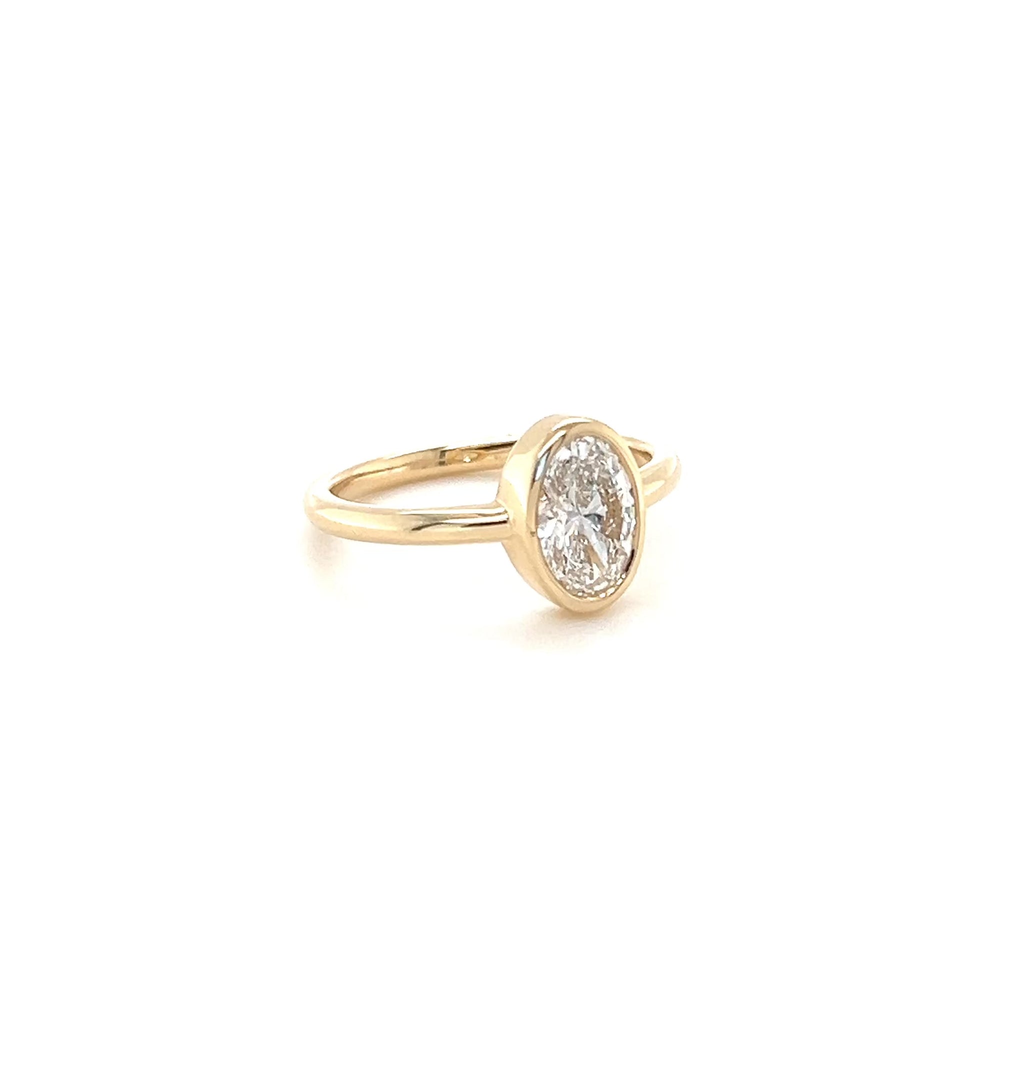 Video of a solitaire diamond engagement ring on a white background. 