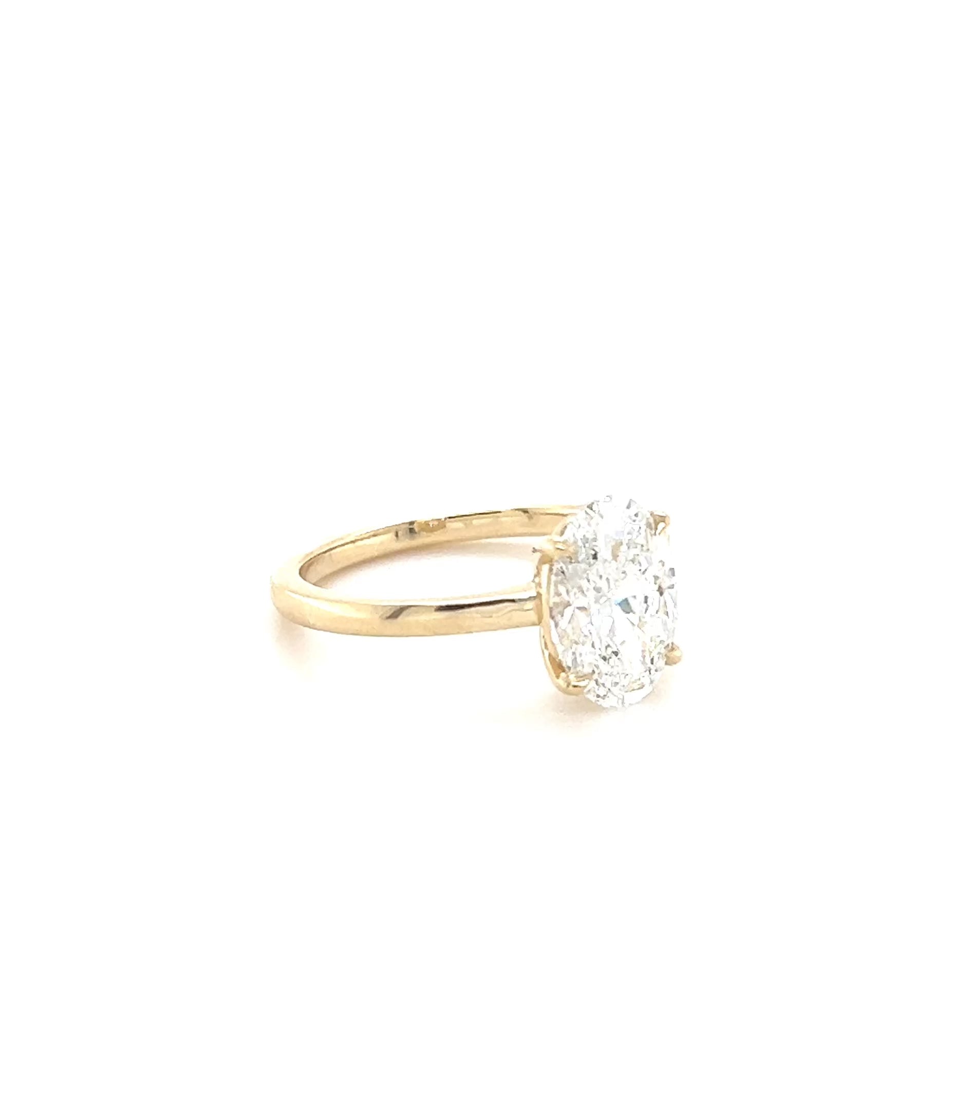 Over the Moon low-set oval lab diamond ring rotating on a white background