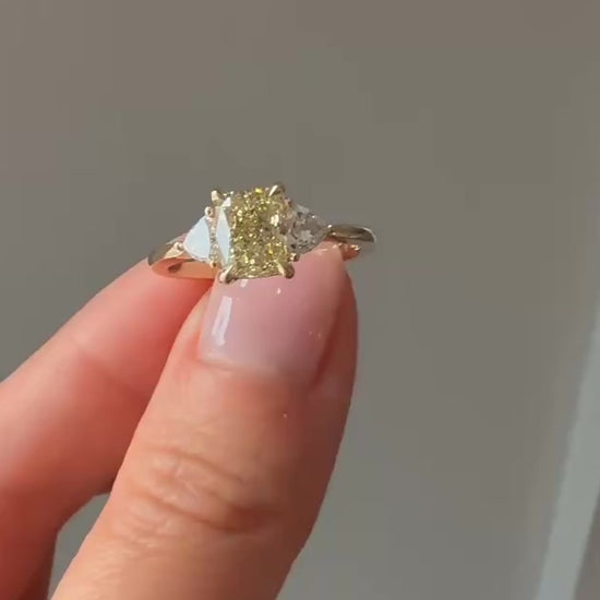 Golden Hour cushion cut yellow lab diamond engagement ring in 14k yellow gold with trilliant side stones showing sparkle and movement