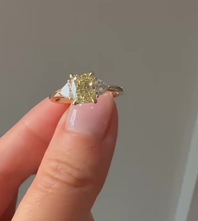 Golden Hour cushion cut yellow lab diamond engagement ring in 14k yellow gold with trilliant side stones showing sparkle and movement